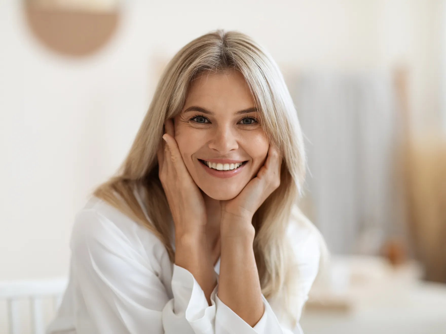 a woman with blonde hair smiling at the camera