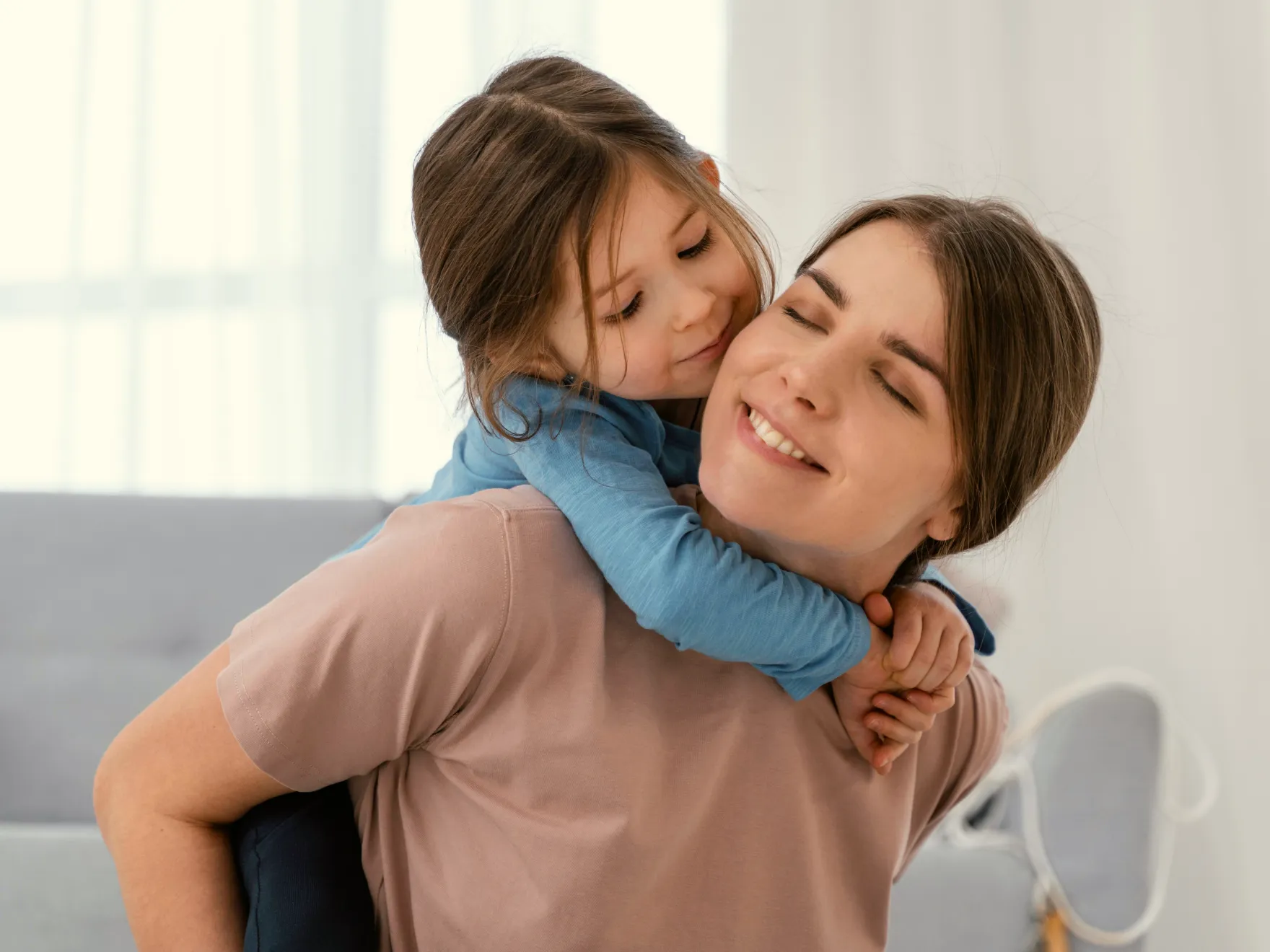 a woman holding a little girl in her arms