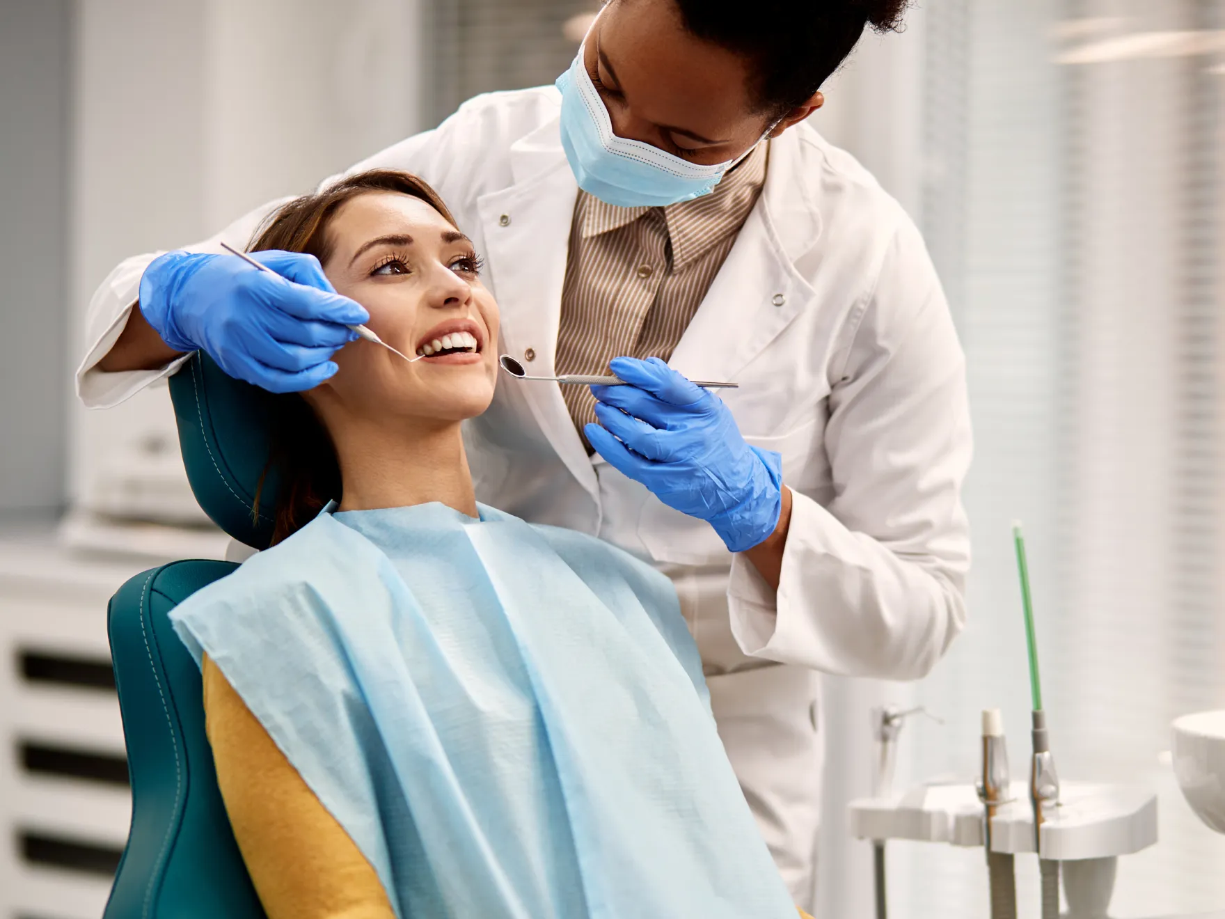 a woman getting her teeth checked by a dentist